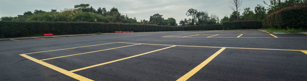 wet parking lot with black asphalt after rain